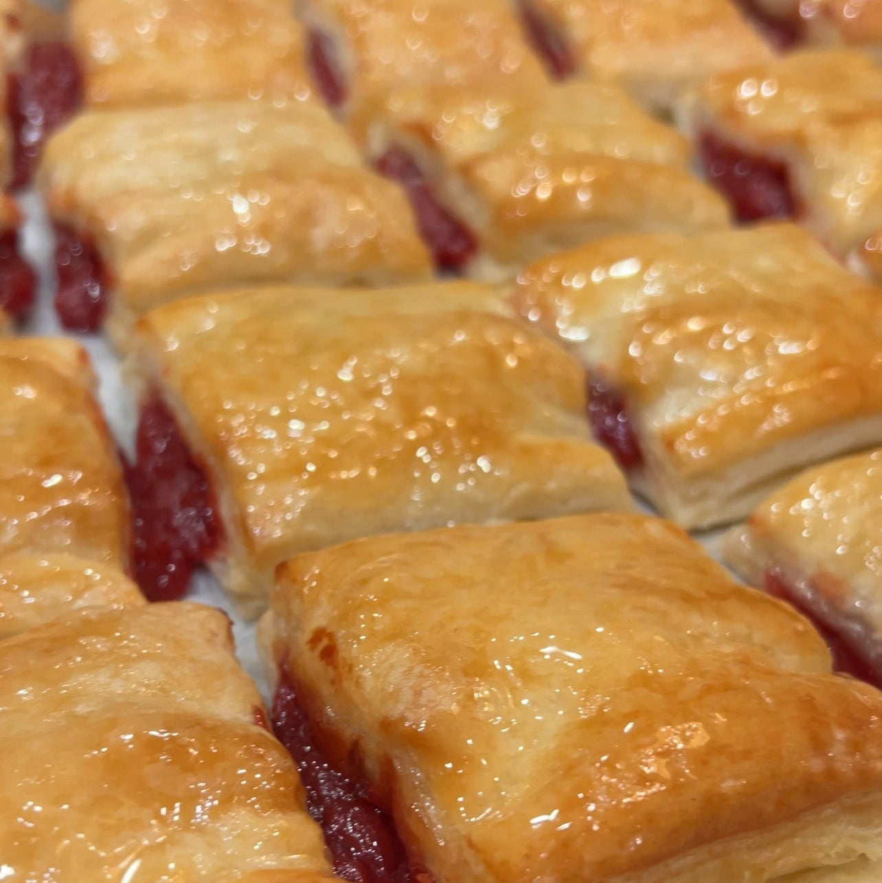 Baked pastry with guava fruit filling on a baking tray